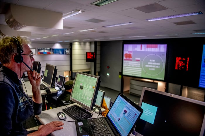 A man who is looking at data on computers.