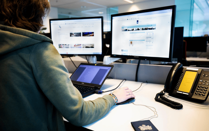 Een vrouw aan het werk achter schermen