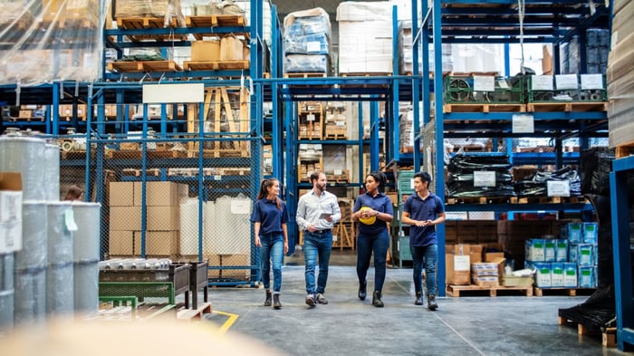 Employees walking through a warehouse.