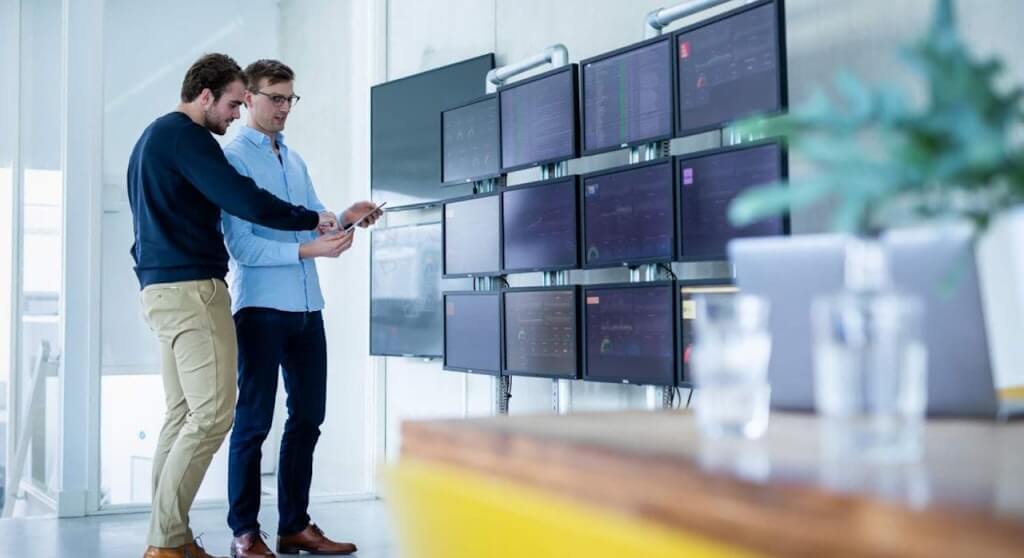 Two people in front of computer screens