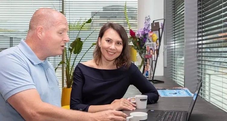 Colleagues behind computer.