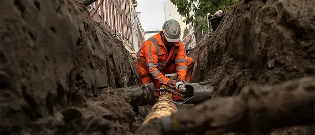 Construction worker working with underground cable 