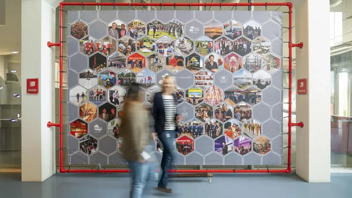 Two people walk by a poster