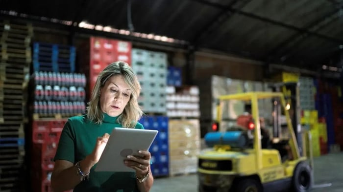Women with a tablet in her hands in a fabric storage