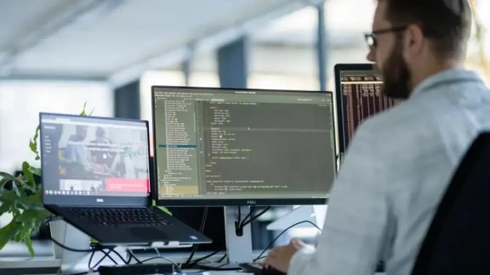 Man behind his desk with screens