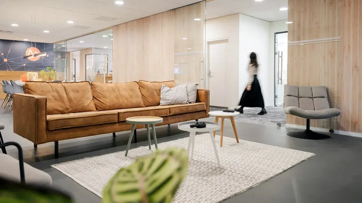Woman walks through the office in a dress.