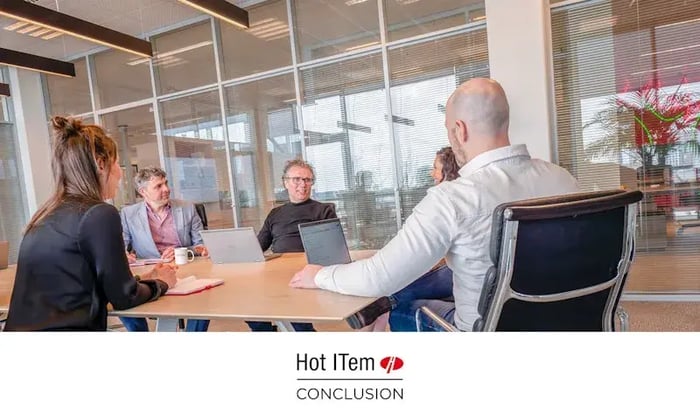 Four colleagues in a meeting room.