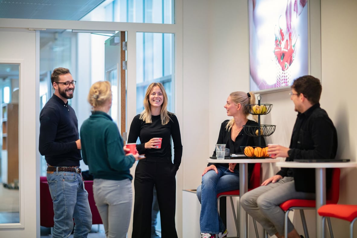 Collega's van intelligence staan koffie te drinken op de werkvloer.