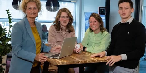 vier collega's om een statafel