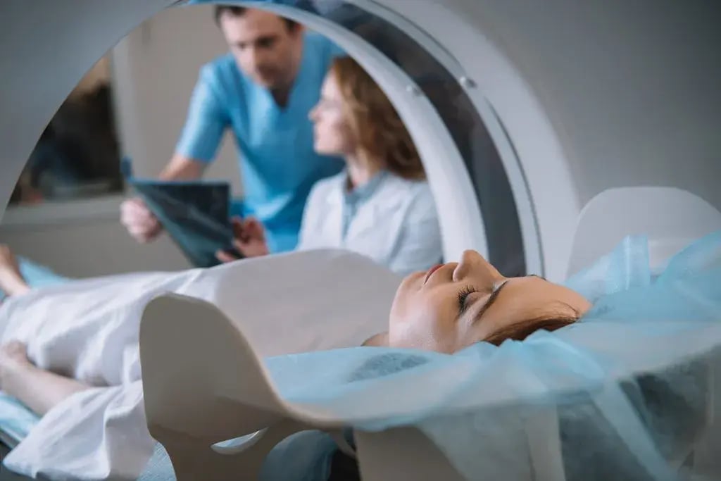 A lady has a PET-scan while two doctors look at the results