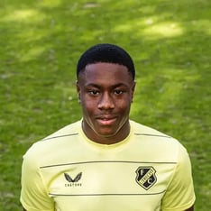 A portrait photo of an FC Utrecht football player in a yellow shirt.
