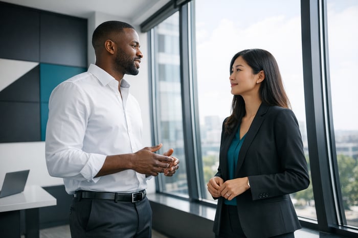 Office Workers Chatting at Large Window