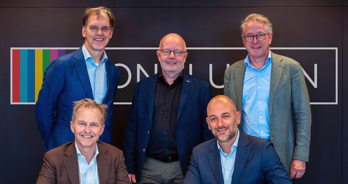 Five men posing in front of Conclusion Logo