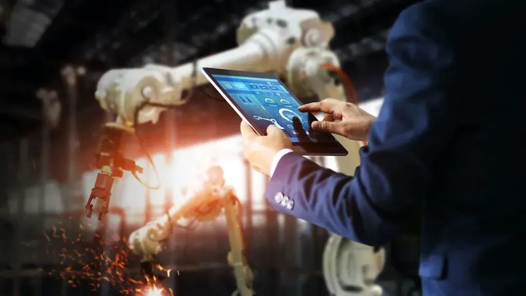 Man uses an iPad to control a robot