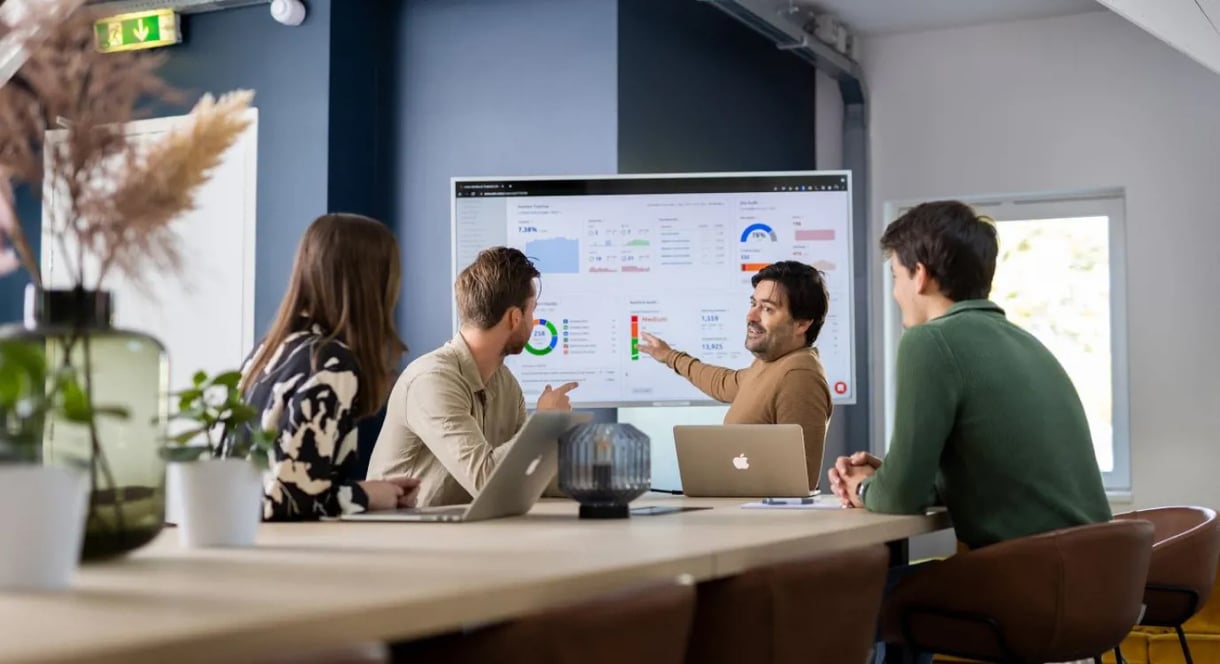 4 people having a meeting in a meeting room