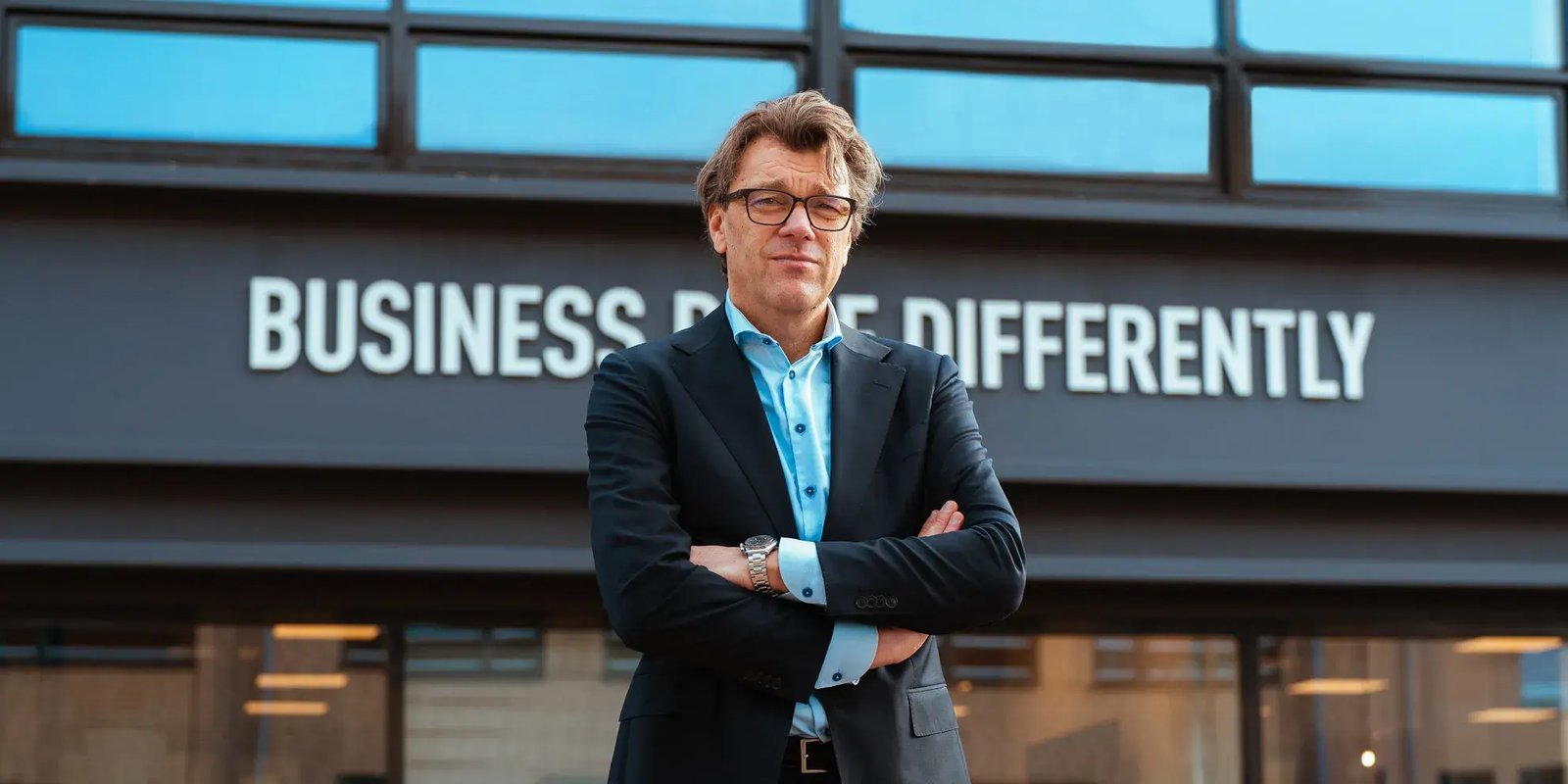 Man in pak met zijn armen over elkaar