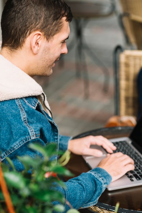 man-using-laptop-urban-environment