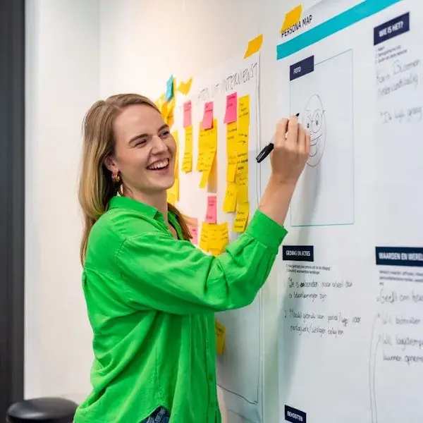 Collega tekent iets op een whiteboard,